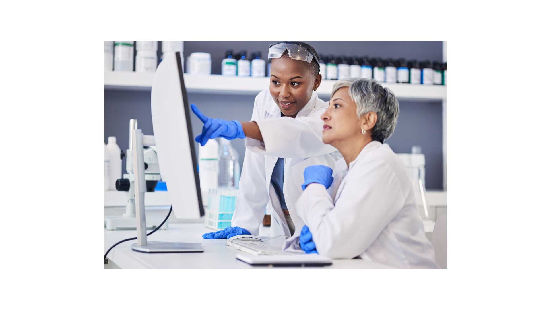 Two doctors look at a computer screen