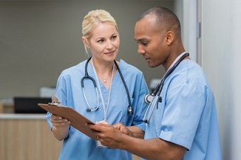 Nurse helping to educate coworker