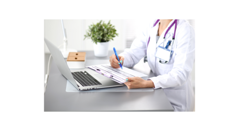 Clinician at a laptop computer with a plant in the background